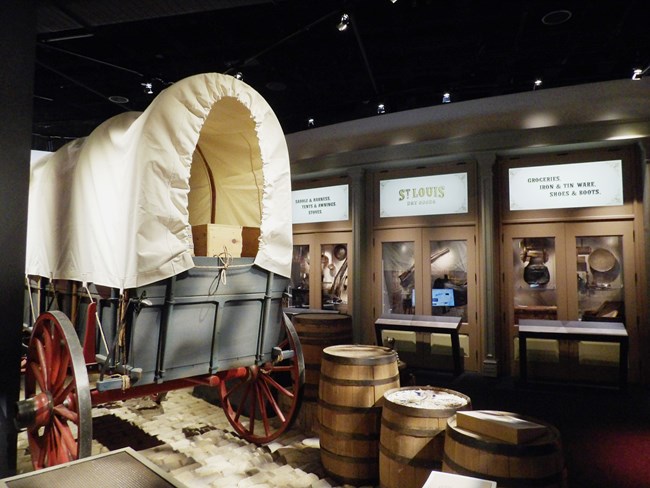 covered wagon in front of commercial wares display