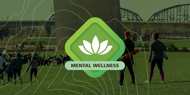 a green diamond graphic with a lotus flower in the center and the words Mental Wellness on top of a green tinted photo of people carring yoga mats on the Arch grounds and people doing yoga in the background with the leg of the Arch visible. The photo has