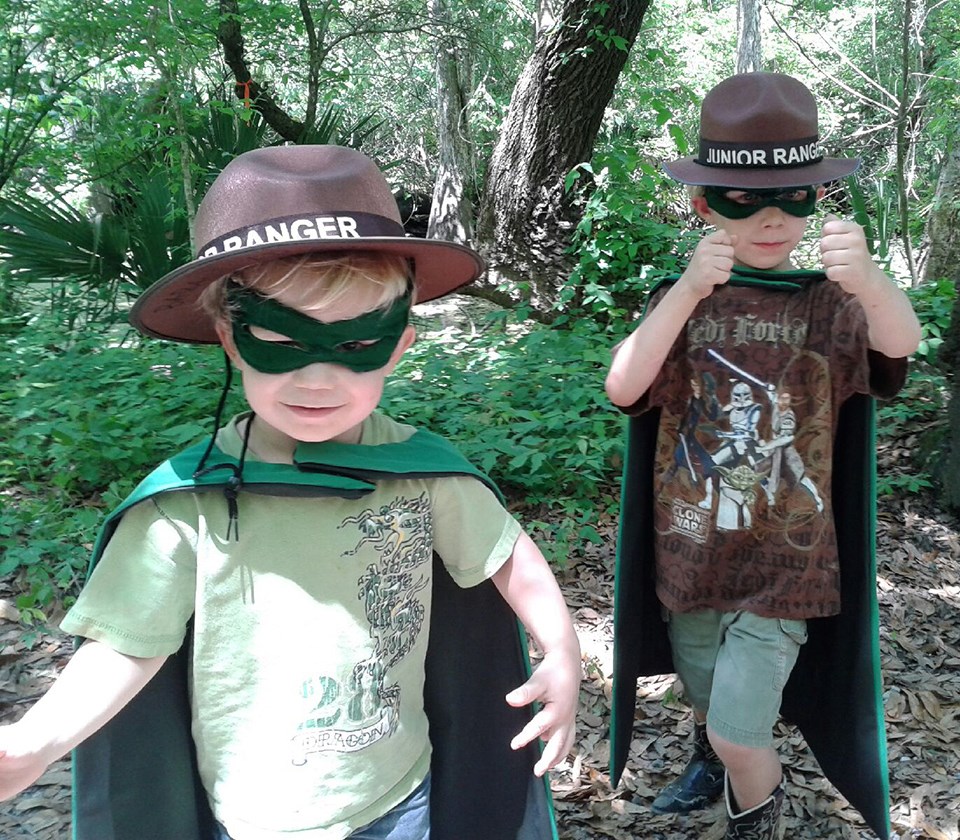 Two little boys wearing Junior Ranger hats and superhero capes Two little boys wearing Junior Ranger hats and superhero capes