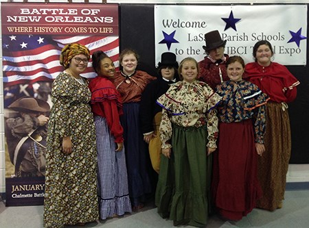 Eight Choctaw youth dressed in men's and women's attire of the War of 1812 era.