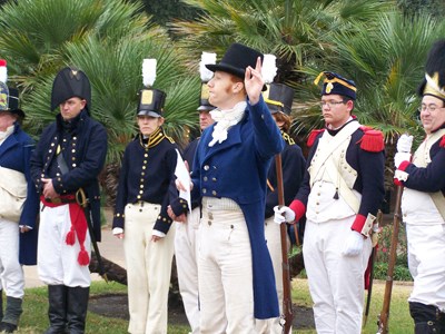 A living history reeanactor delivers a speech to troops dressed in War of 1812 uniforms A living history reeanactor delivers a speech to troops dressed in War of 1812 uniforms