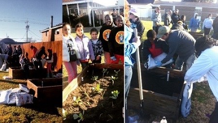 Young volunteers adding soil and plants to outdoor garden boxes.