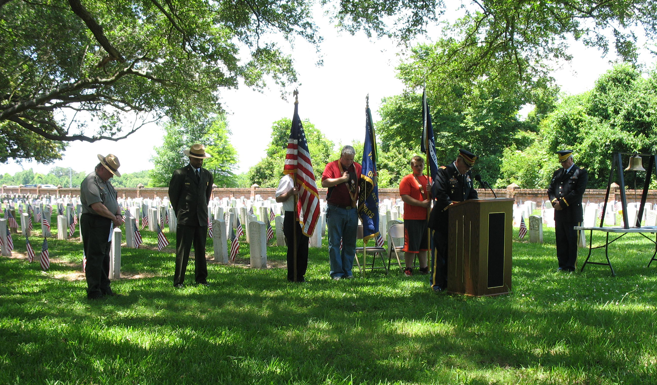 Image of people with bowed heads during Memorial Day ceremony at Chalmette National Cemetery Image of people with bowed heads during Memorial Day ceremony at Chalmette National Cemetery