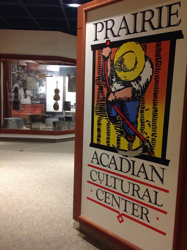 Entry to Prairie Acadian Cultural Center with logo and exhibits