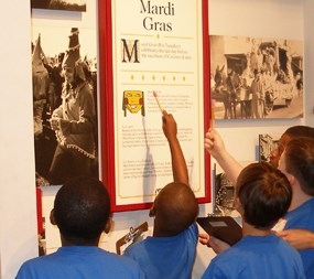 Boys in school uniforms look at a display in the Acadian Cultural Center Boys in school uniforms look at a display in the Acadian Cultural Center