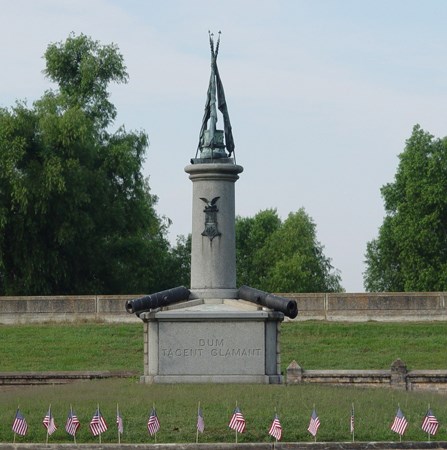Image of Civil War Grand Army of the Republic monument at Chalmette National Cemetery with American flags around it