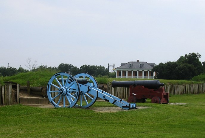 Image of War of 1812 cannons, rampart, and historic house at Chalmette Battlefield