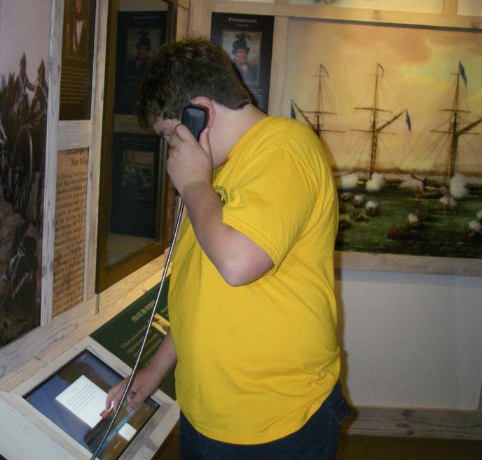 Image of boy at computer interactive exhibit in Chalmette Battlefield Visitor Center
