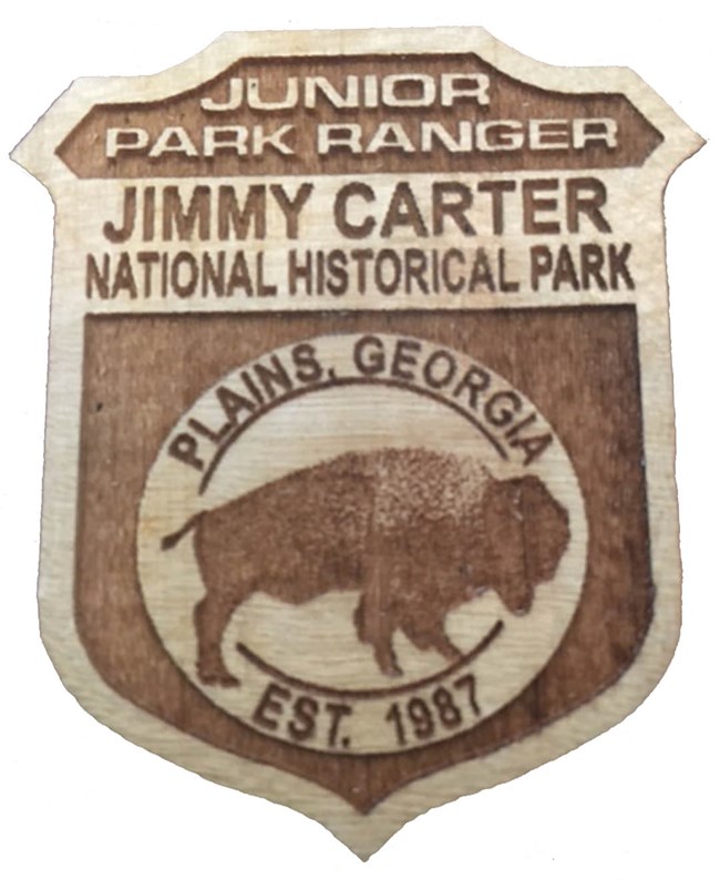 a wooden Jr Ranger badge from Jimmy Carter National Historical Park