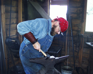 Park Ranger Kevin Alexander blacksmiths at the Boyhood Farm.