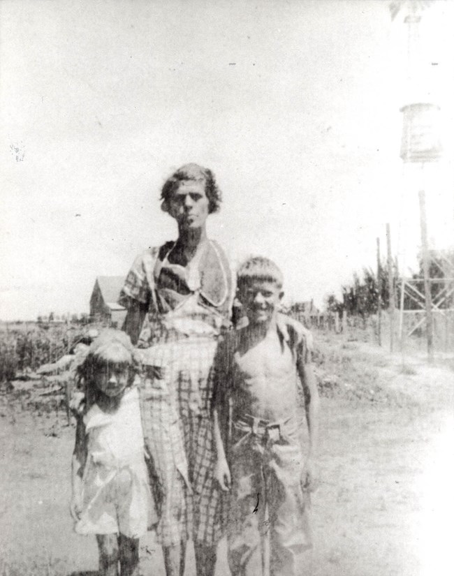 windmill with Ruth, Lillian, and Jimmy Carter standing in the foreground