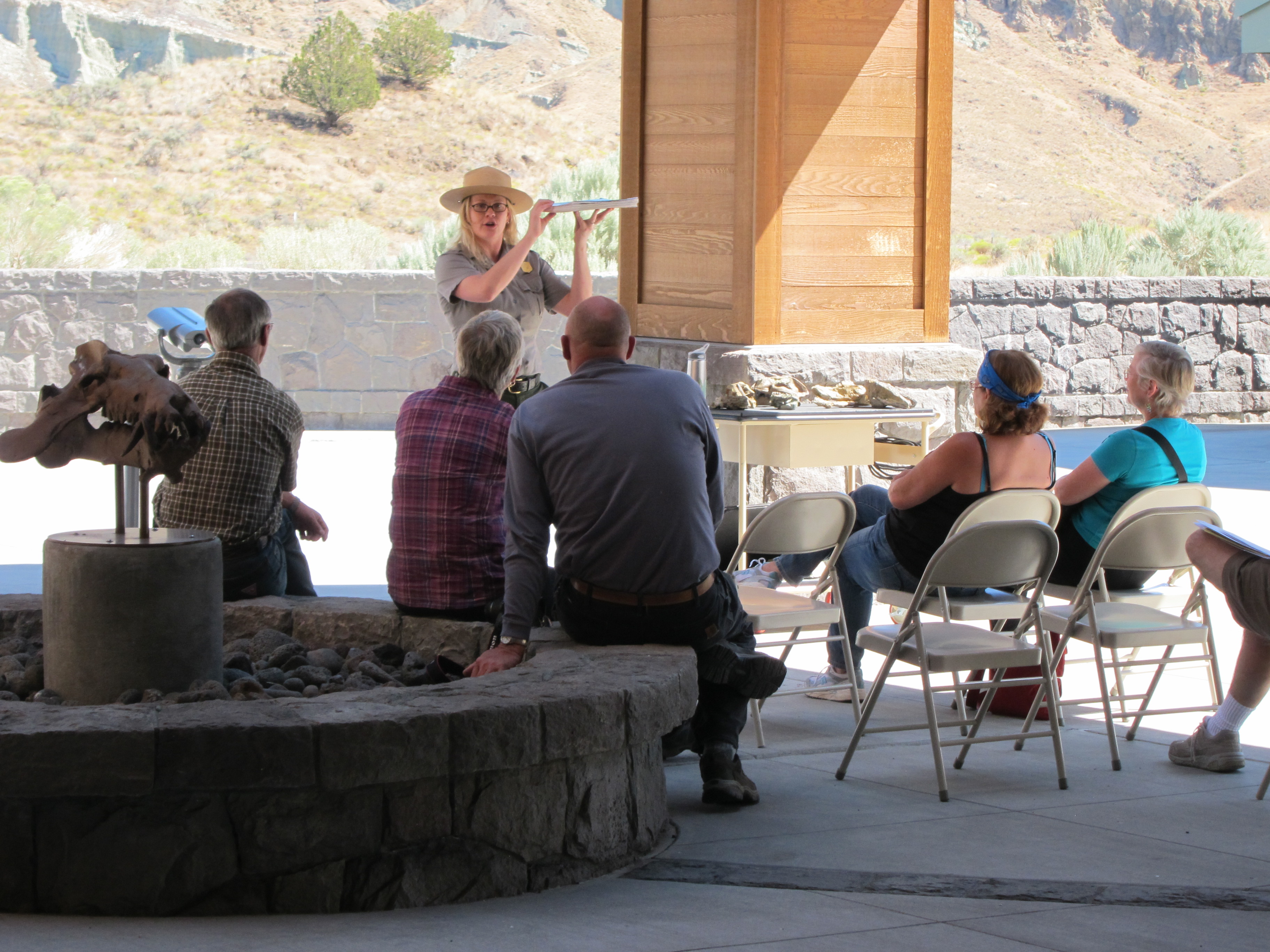 A park ranger holds up a skeleton as she discusses to an audience, the ancient animals found at John Day Fossil Beds.