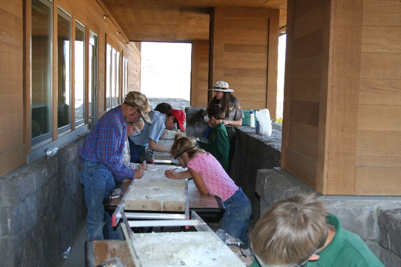 Students examine the "fossils" in a simulated dig outside of the Thomas Condon Paleontology Center.