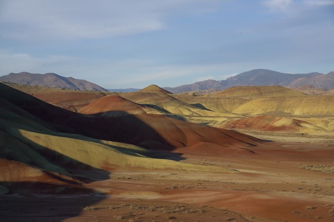 Panoramic view of colorful red and yellow striped hills