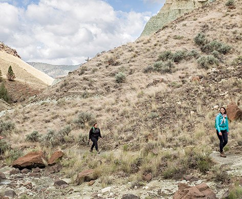 Two hikers on the Blue Basin trail are six feet apart from each other, demonstrating social distancing.