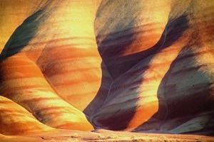 Low light at sunset casts dramatic shadows within the hills Close up of the Painted Hills with shadows in ripples.