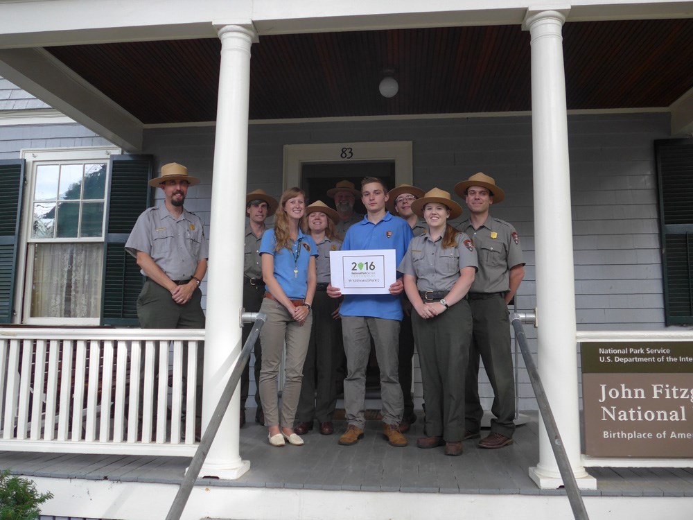 Rangers, volunteers and interns stand in front of JFK's birthplace