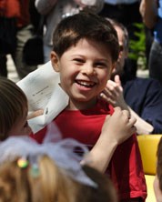 Students congratulate a classmate after he wins an award in the "What John F. Kennedy Means to Me" Essay and Poetry Program