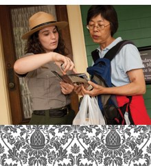 A ranger explains part of a site brochure.
