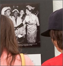 Visitors looking at a photograph of Mrs. Rose Kennedy taken during a 1952 campaign tea.