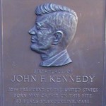 The town of Brookline placed this bronze, bas-relief plaque in the front yard of 83 Beals Street in 1961 to recognize the birthplace of the newly elected president.  Below a portrait of Kennedy, the text reads: “Birthplace of John F. Kennedy  35th President of the United States  Born May 29, 1917 on this site  83 Beals St., Brookline, Mass”