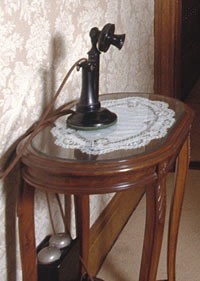 Historic telephone on small table.