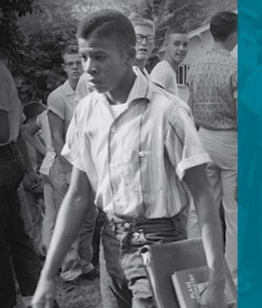 An African-American boy enters an all-white school for the first time.