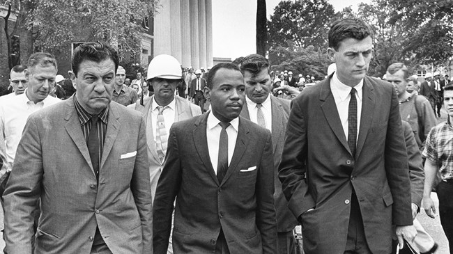 A group of men in suits walking