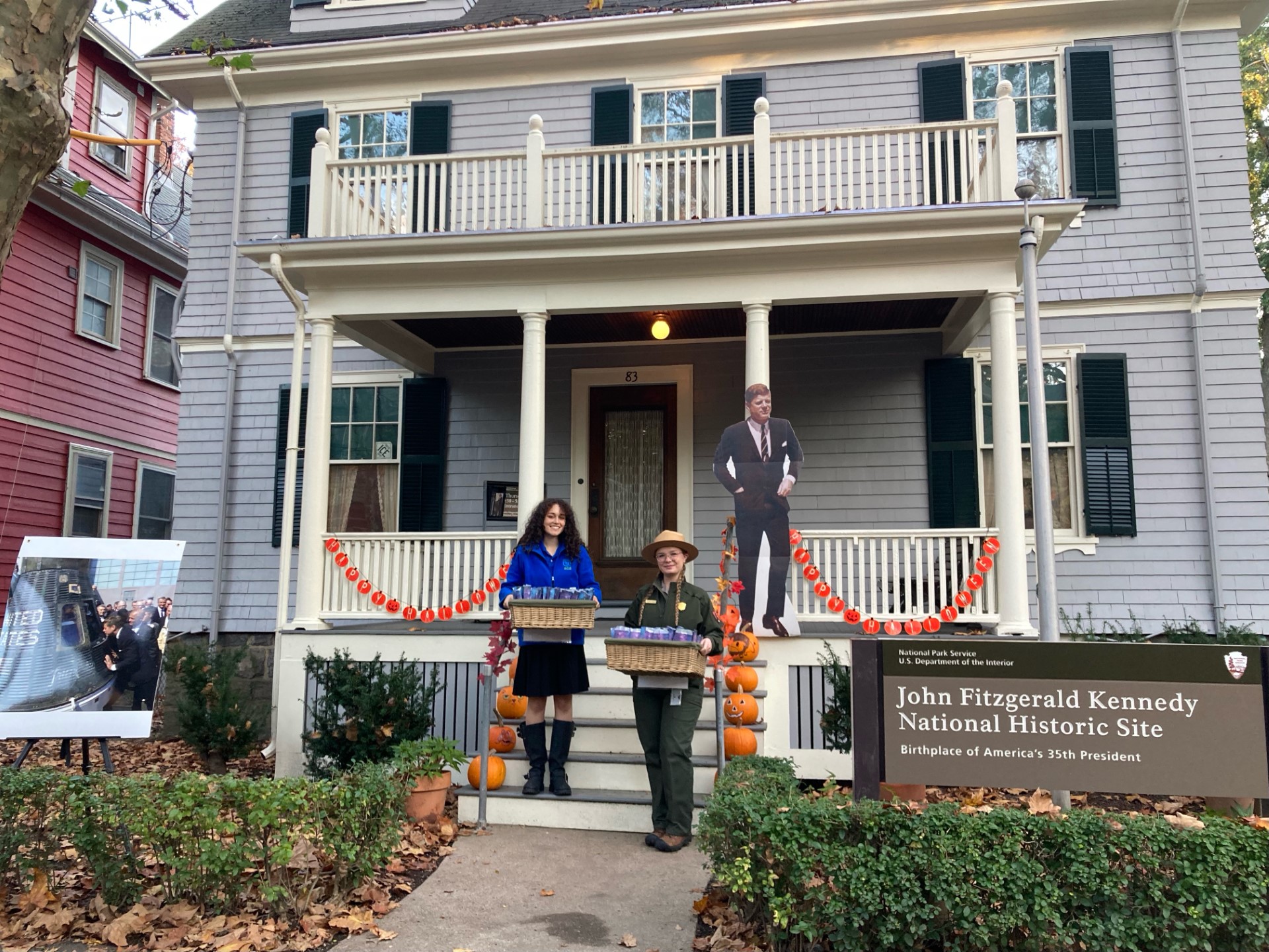 halloween_event4 Park Staff stand in front of JFK NHS a grey house with green shutters