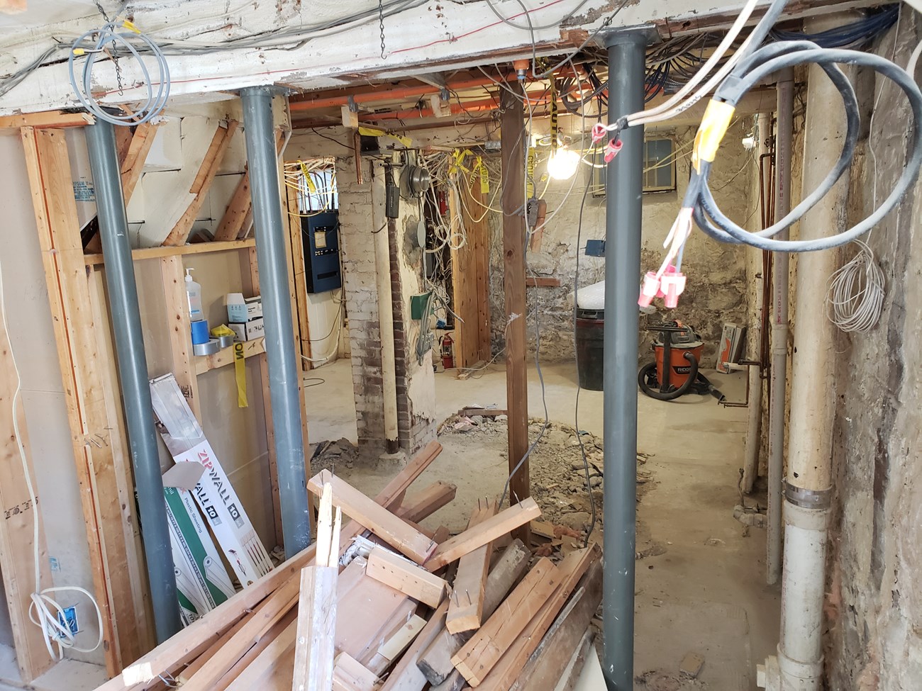 A view of the basement visitor center under renovations.  Building materials and cables are visible.