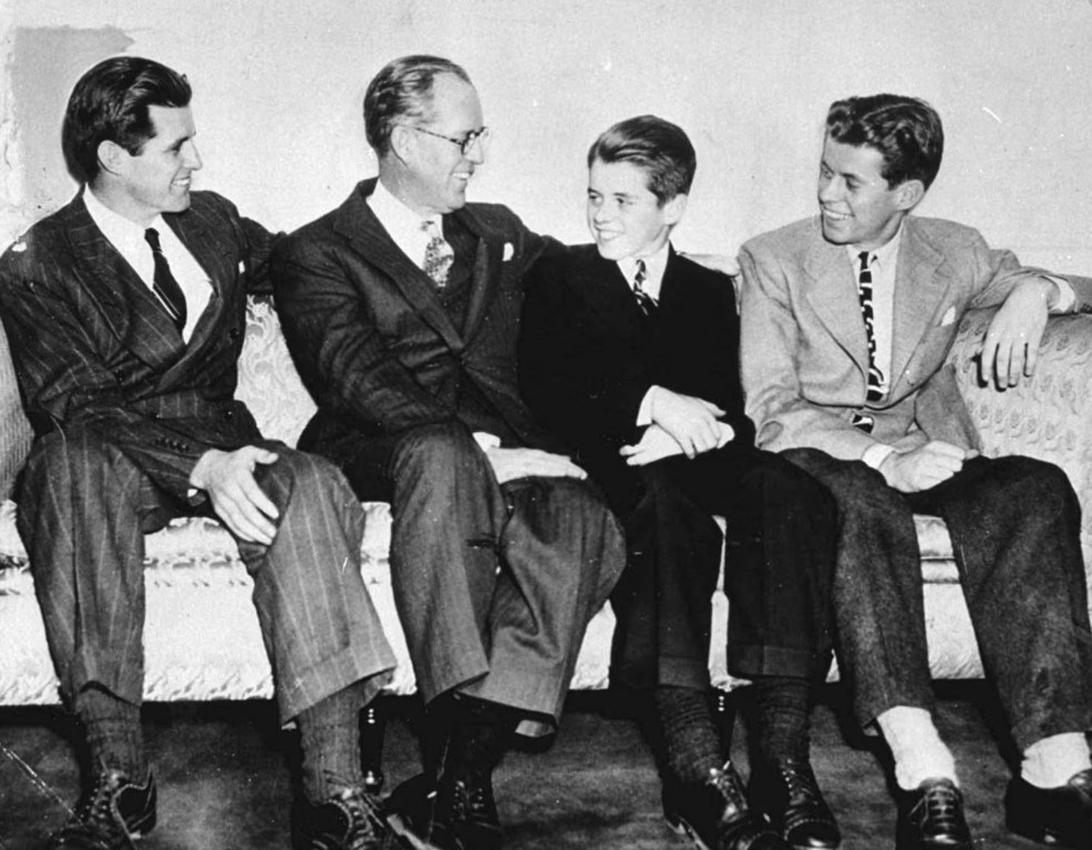 Black-and-white photo of Joe Jr., Joe Sr., RFK, and JFK