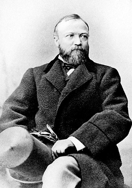 A photo of Andrew Carnegie seated.