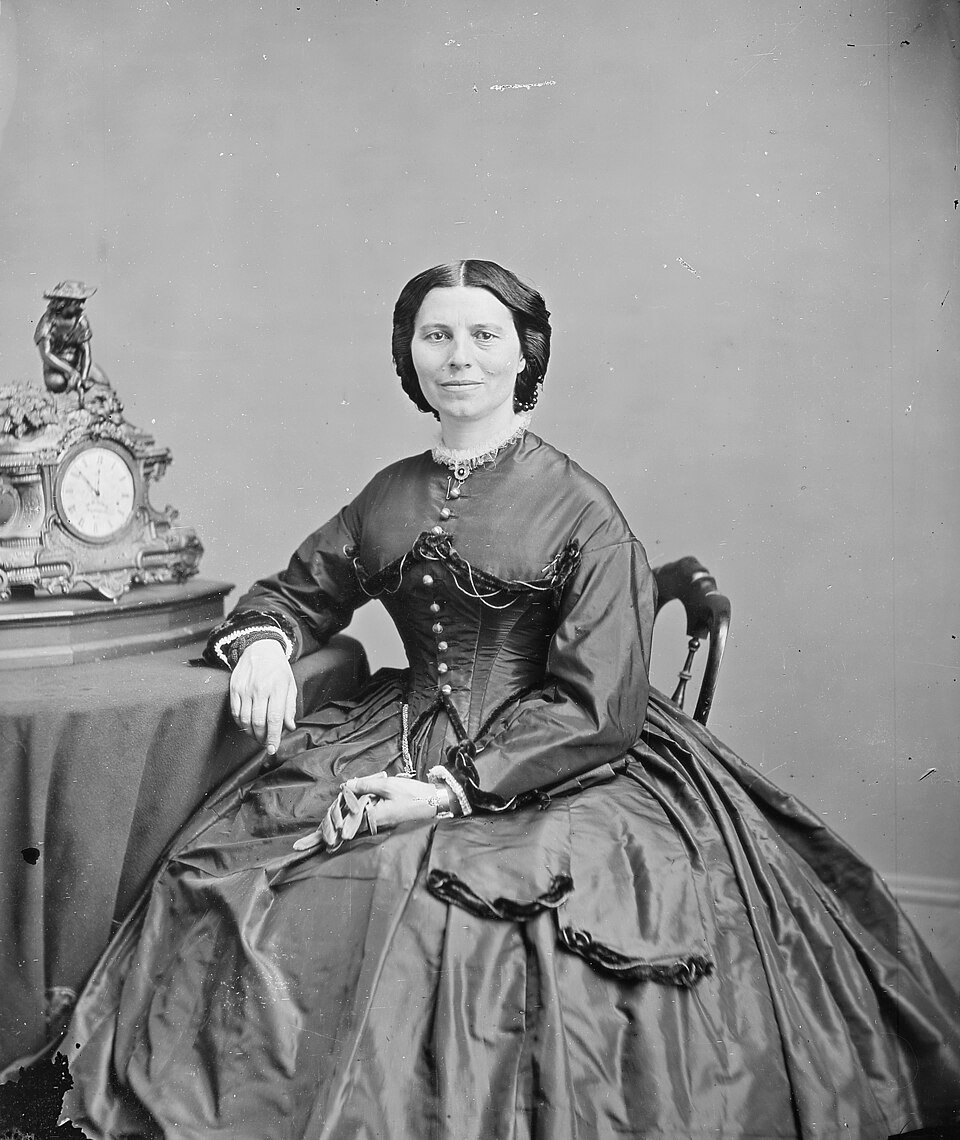 A woman in a dark dress with dark hair