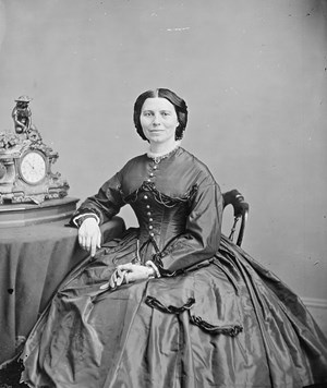 A woman in a dark dress with dark hair