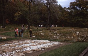 People looking at a stone foundation
