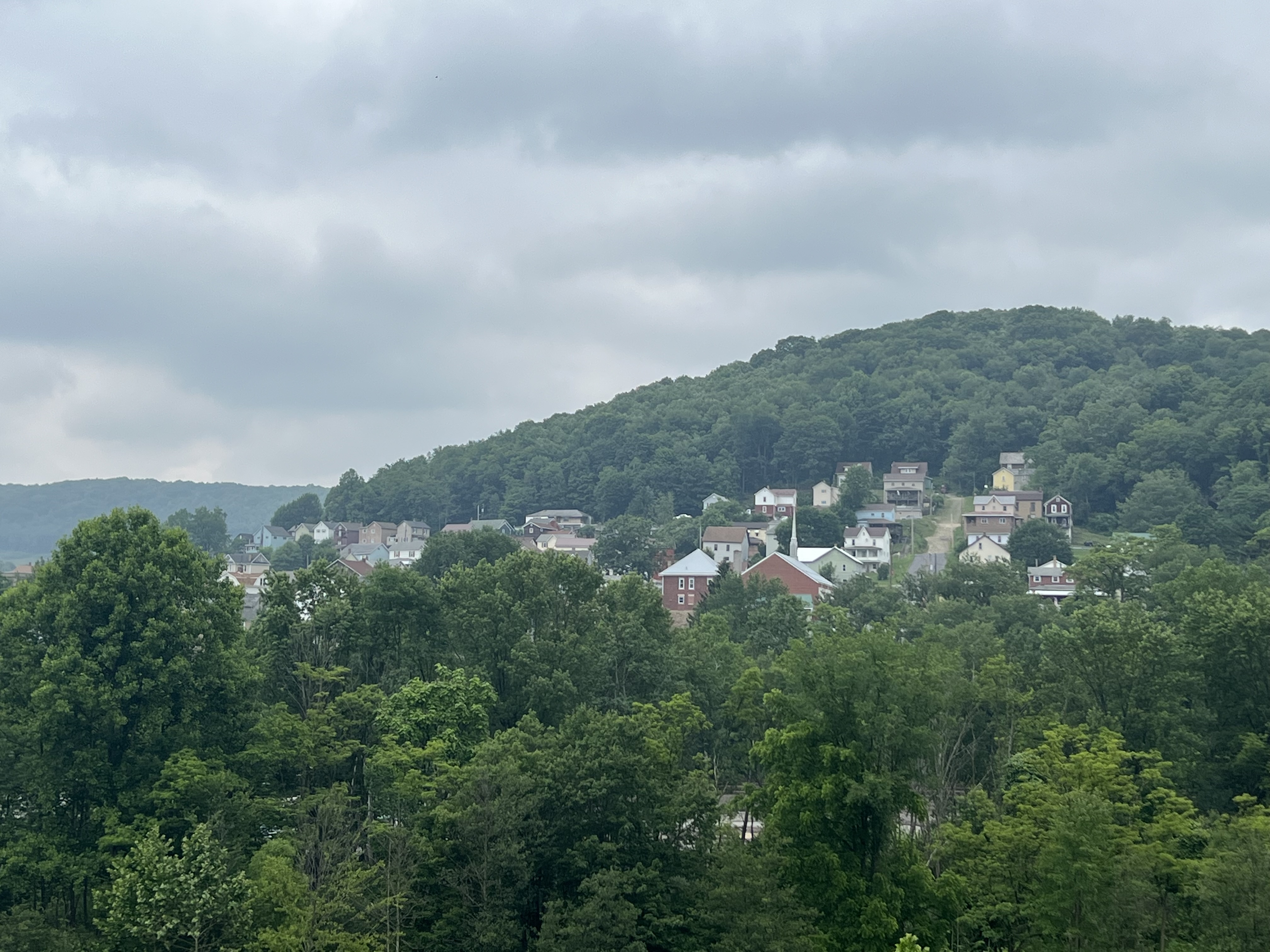 A view of a town on a hillside.