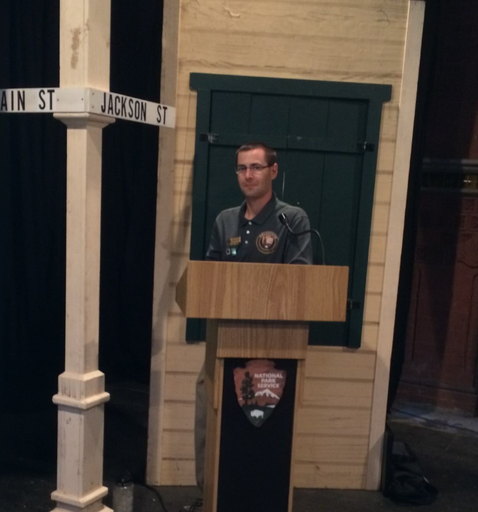 A park volunteer standing at a podium.