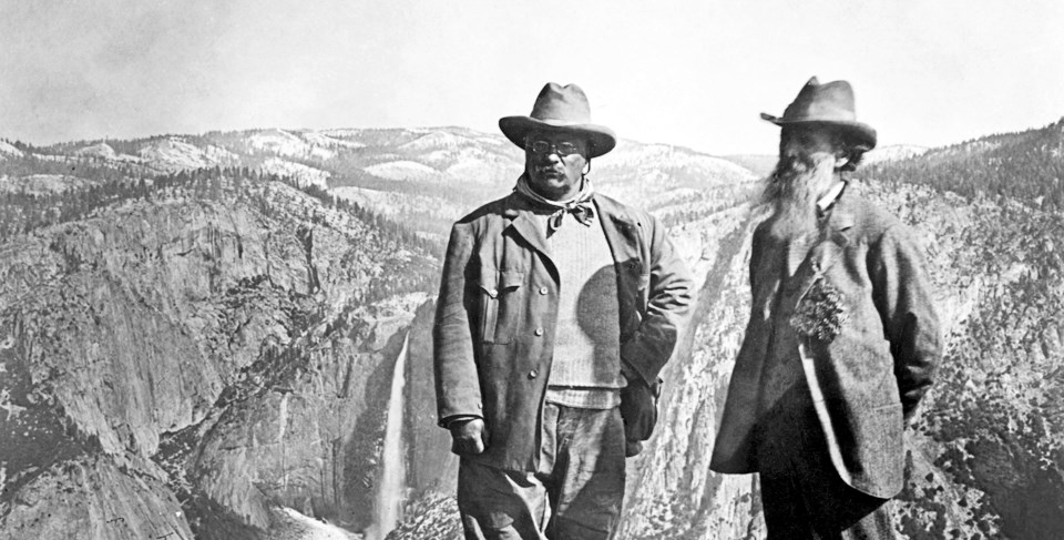 John Muir and President Roosevelt standing on a mountain at Yosemite.