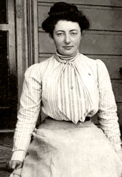 Wand Muir, young woman in dress, sitting on the porch.