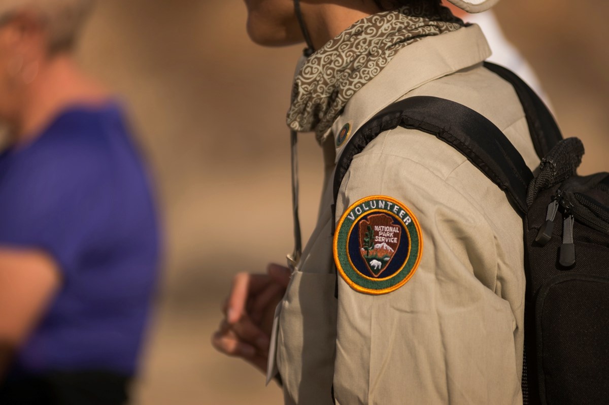 Close-up of a volunteer patch on the arm of a tan shirt. Photo: NPS / Kurt Moses