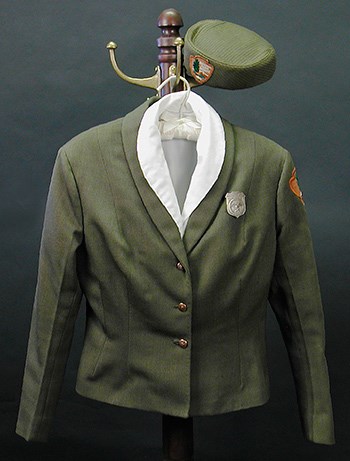 vintage ranger uniform pieces hanging on a coatrack