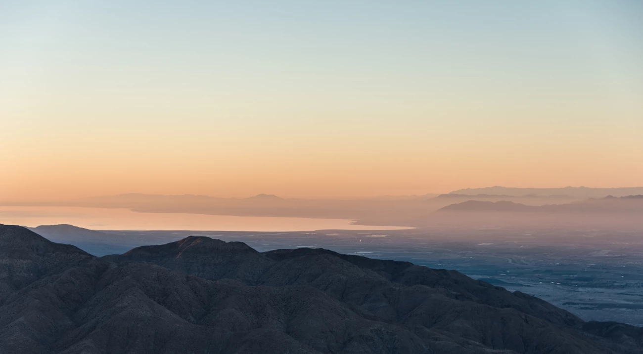 Keys View at Sunset Looking out over the Salton Sea from Keys View. It is just after sunset and the light is very pink. The foreground mountains are blue.