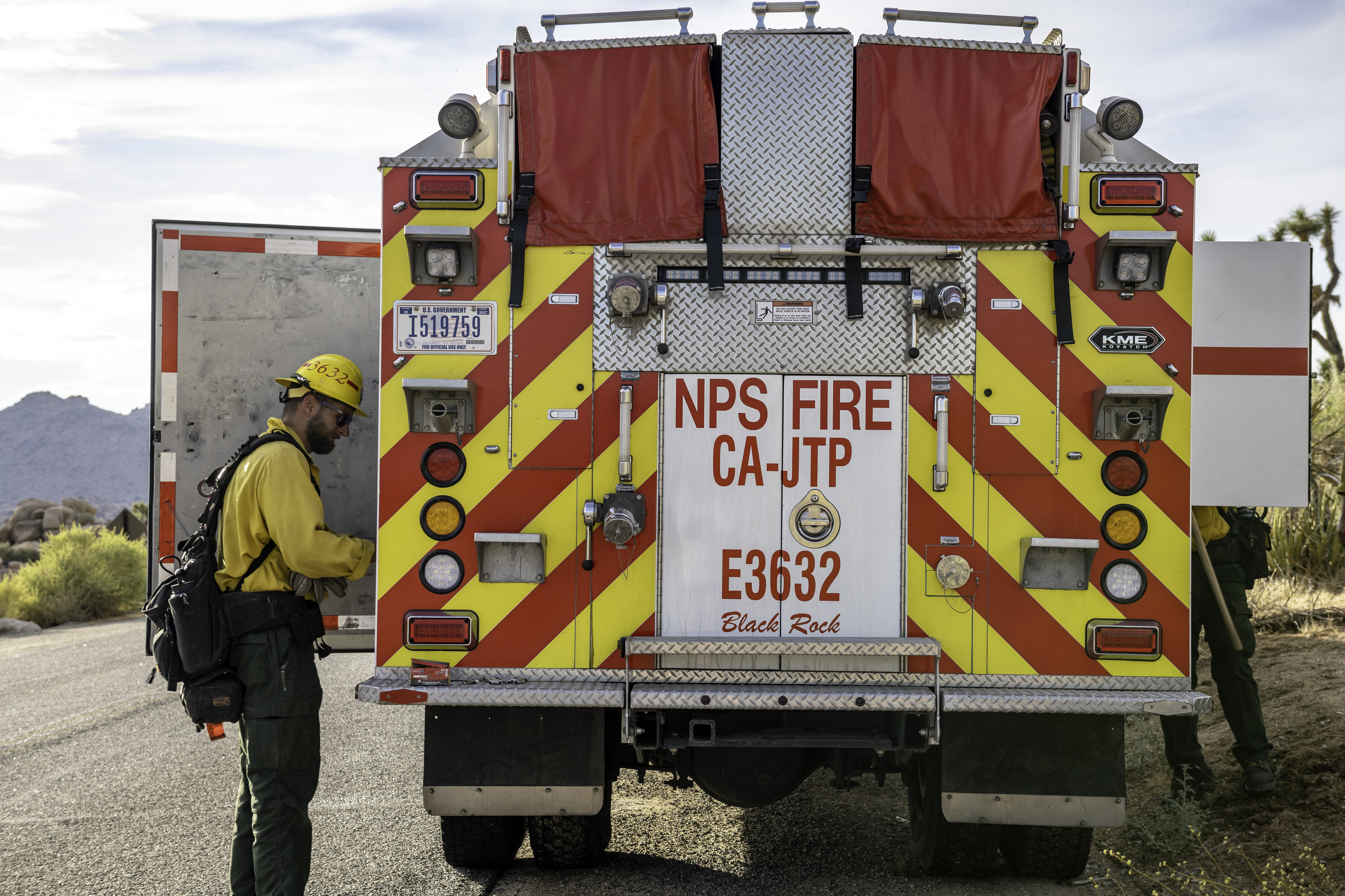 A firefighter at a firetruck with words reading NPS Fire CA-JTP.