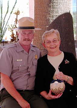 Superintendent Curt Sauer accepts the ornament from artist, Audrey Gillick.