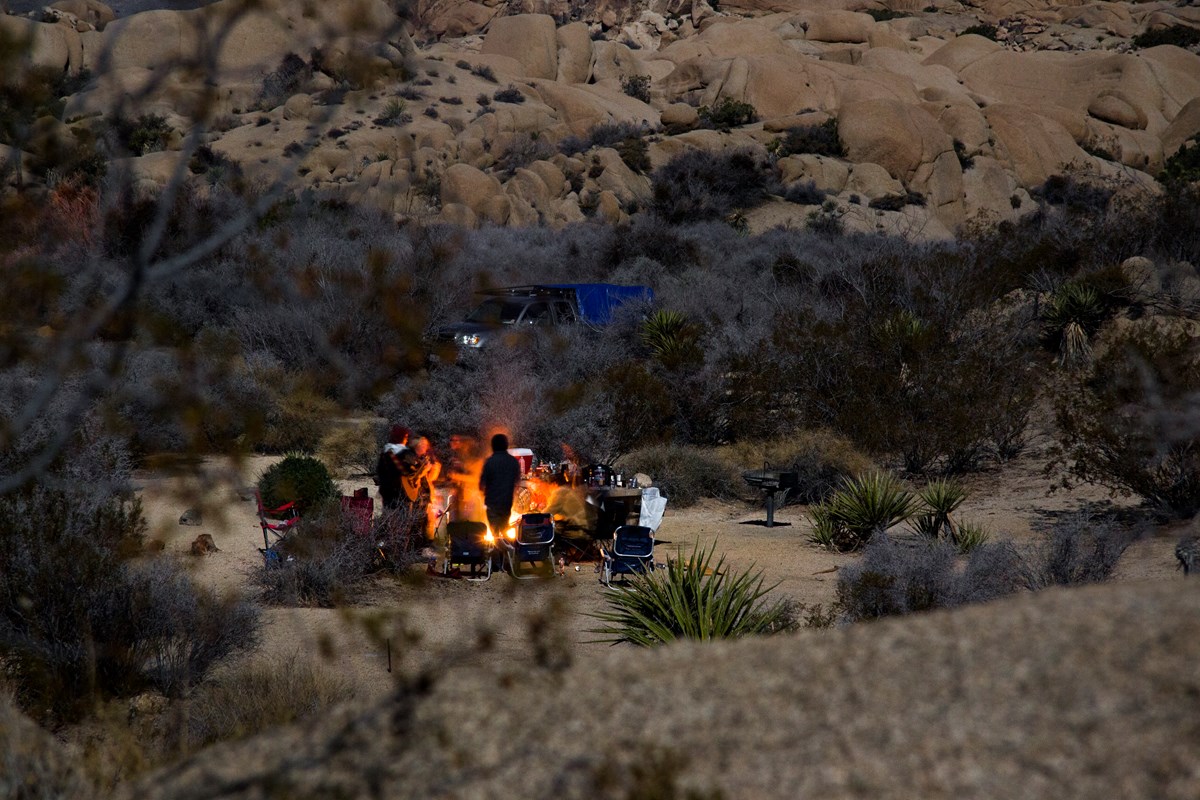 Campers gather around the fire ring at the Jumbo Rocks Campground. NPS / Brad Sutton Campers gather around the fire ring at the Jumbo Rocks Campground. NPS / Brad Sutton