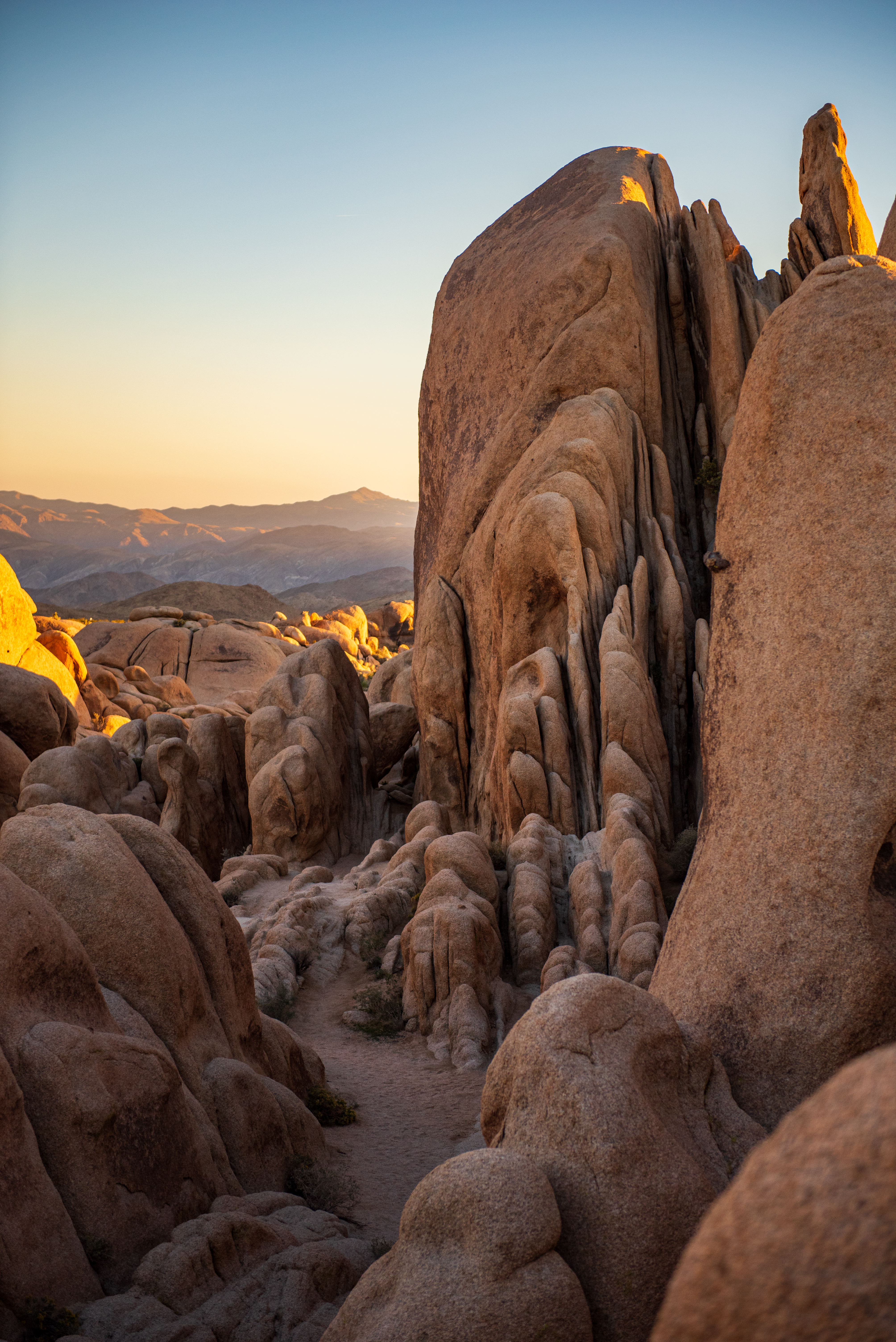 Boulders in the desert, blue sky above.