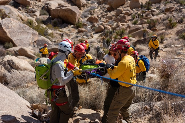 the search and rescue team practice lowering a litter