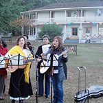 musicians in front of adobe