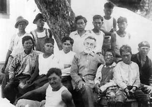 A black and white image of a group of men and boys looking at the camera