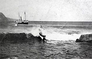 A black and white image of two boats on the ocean, one in waves